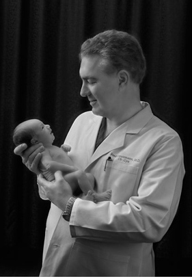 Dr. C with Smiling New Baby